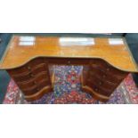 An Edwardian mahogany ladies writing desk fitted with six drawers and side cupboard. Gallery rail to