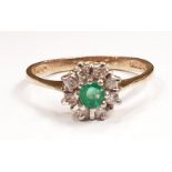 A 9ct gold emerald and diamond flower ring, Size O.