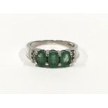 An Emerald accent diamond 925 silver ring, Size N 1/2.