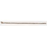 A Diamond 9ct gold line bracelet.