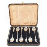 Set of six silver coffee spoons with Asian finial.