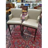 A pair of modern leather bar stools.