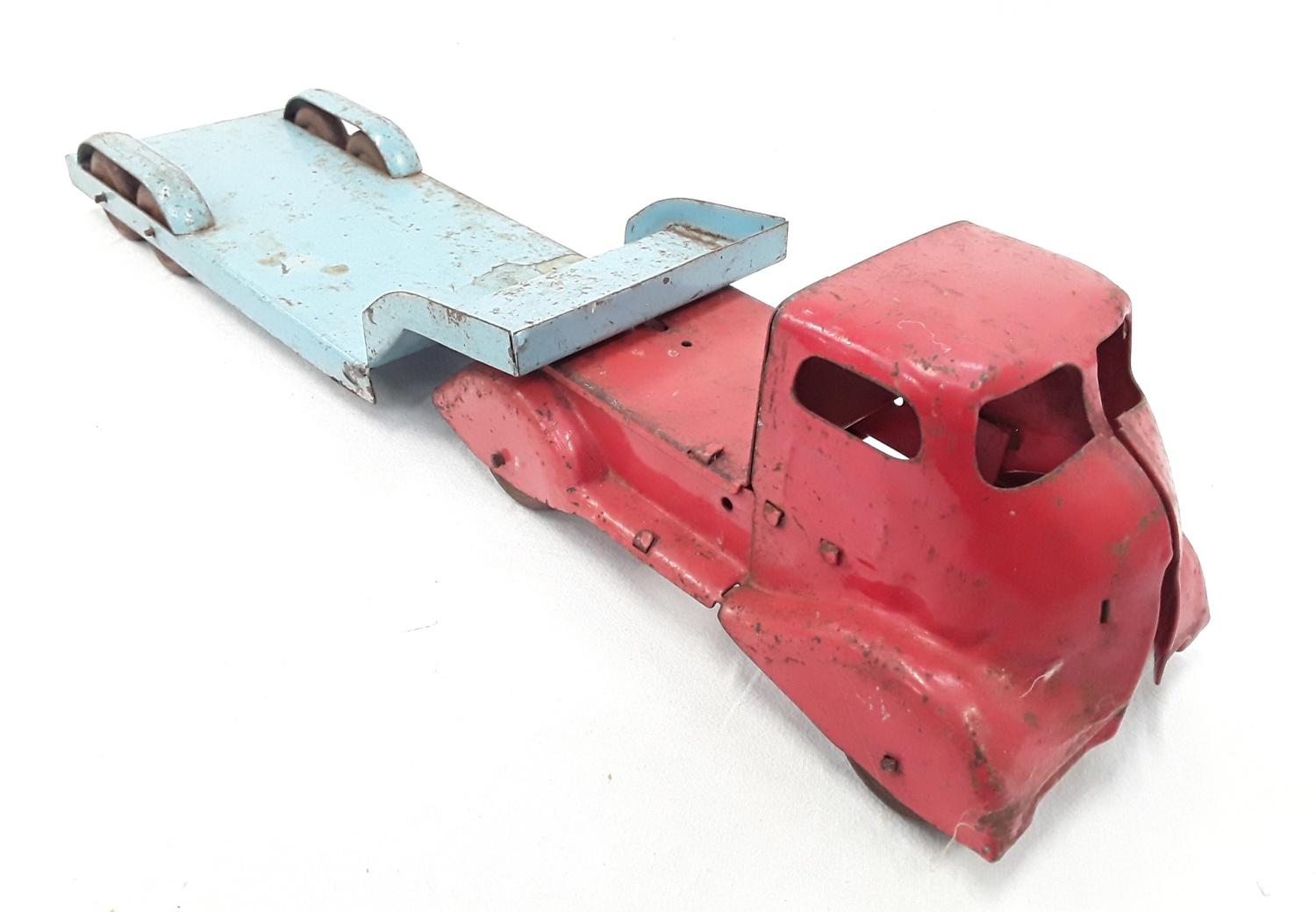 A tinplate red and blue low loader.