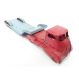A tinplate red and blue low loader.
