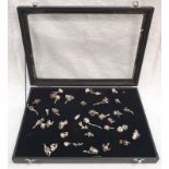 A display case containing approx 40 silver charms.
