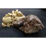 Part fossil together with a soapstone carved ornament.