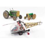 A pair of tinplate Mettoy tractors, together with a Daiya (Japan) helicopter with key.
