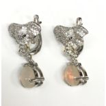 A pair of Silver CZ moonstone elephant earrings with Sapphire eyes.