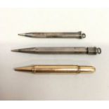 A Gold Asprey pencil with a silver pencil and one other.