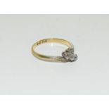 An 18ct gold and platinum three stone diamond twist ring, Size O.