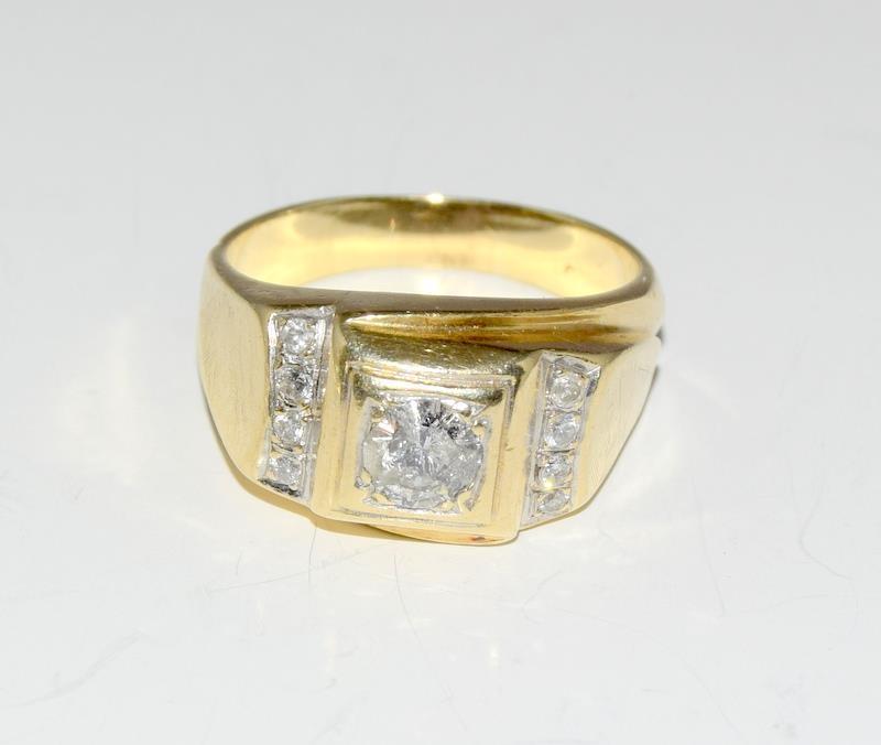 A Gents diamond solitaire 0.75 points with diamond shoulders set in 8.6g 14ct gold ring, Size N.