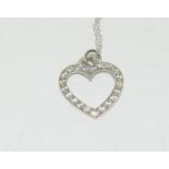 White gold heart shaped Diamond set pendant necklace on gold chain.