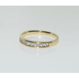 A ladies 14ct diamond 1/2 eternity ring, Size M.