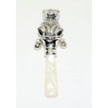 Silver babies rattle in the form of a teddy bear with Mother of Pearl handle.