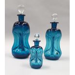 Three graduated blue dimple Danish Kastrup glass decanters.