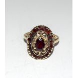 A ladies garnet ring set in 9ct gold. Size M.