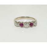 A large ruby and diamond five stone ring, size R.