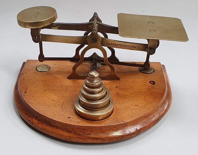 Vintage brass postal scales and weights.