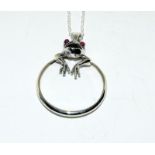 Silver magnifying glass in the form of a pendant necklace with frog finial.