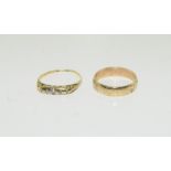 An 18ct gold ladies diamond ring and 9ct gold wedding band.