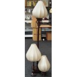 A set of three modern dark wood lamps with fabric shades to include standard lamp, table lamp and