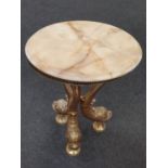 A vintage marble topped small lamp table resting on tripod brass base depicting fish. 47cm High.