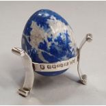 A silver stand London 1977 with a blue ceramic egg.