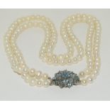 Pearl twin string necklace with aquamarine clasp.