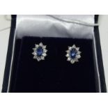 Pair of 18ct white gold Sapphire and Diamond cluster earrings of 1ct approx.
