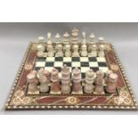 A chessboard with full set of playing pieces.