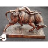 A cast bronze figure of a dancing bull with nude lady on top. 85x40cm.