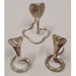 A pair of silver metal snake menu holders together with another.