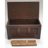 An apprentice oak coffer used as a cigar box with cigars.
