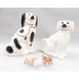 Two Staffordshire flat back dogs and two Beswick dogs.