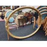 A large gilt framed oval mirror. Marked "Old Times Furnishing Co. Westminster" 109x135cm.