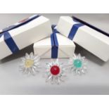 Swarovski Crystal: 3 daisy renewal gifts - yellow, red and green centres (3 retired, with boxes).