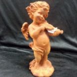 A cast iron statue of an angel playing a violin 29cm high.(144).