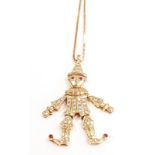 18ct gold diamond clown pendant with ruby eyes.