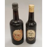 A bottle of Antique King's Ale sealed together with a bottle of Courage 1945 ale sealed.