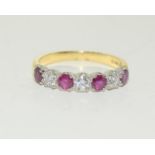 An 18ct gold ladies Diamond and Ruby seven stone ring, Size P. (W1)