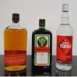 A bottle of Jagermeister together with a bottle of Safeway Imperial Vodka and a bottle of Bulleit