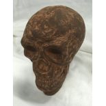 A cast iron skull (130).