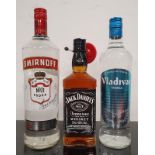 A bottle of Smirnoff Vodka together with a bottle of Vladivar Vodka and a bottle of Jack Daniel's
