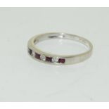 A 9ct gold ladies Diamond & Ruby half eternity ring. Size M. (Ref WP)