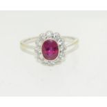 An 18ct white gold ladies diamond and ruby ring, size P.