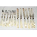 A mother of pearl handle cake knife and fork set with silver mounts