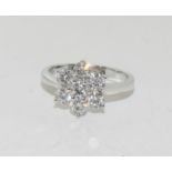 A fine 18ct white gold Diamond flower head style dress ring of 1.3cts. Size O