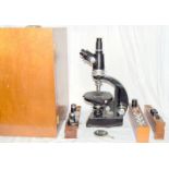 Vickers professional microscope with lenses in its wooden case