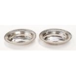 A pair of silver oval dishes.
