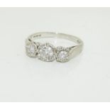 An 18ct white gold ladies three stone diamond ring, approx 1ct, size O